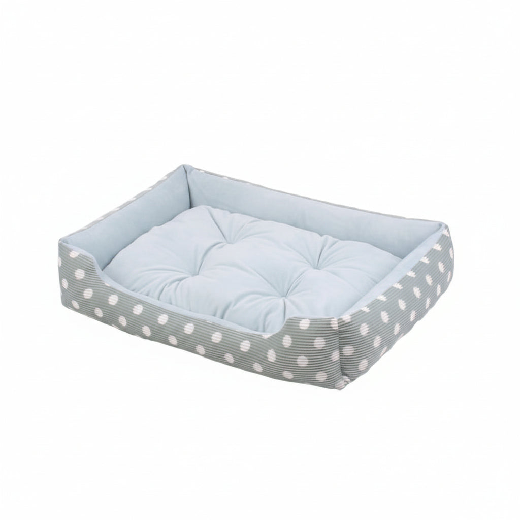 dog bed with a polka dot pattern and a cushion on a white background
