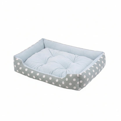 dog bed with a polka dot pattern and a cushion on a white background